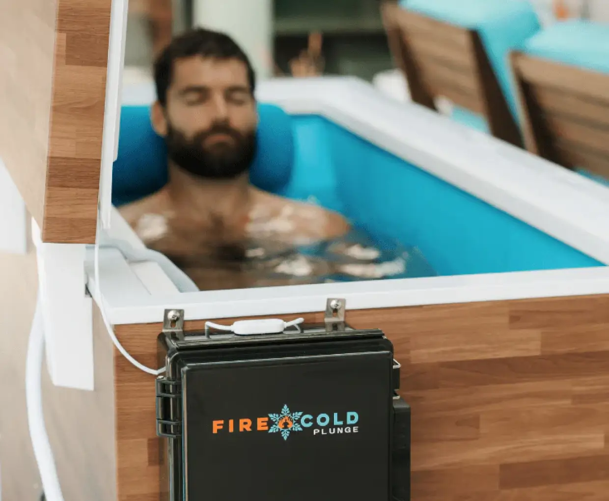 Young man and woman dressed in black and gray carrying matching gray bags with a textured pattern, standing in front of a circular-patterned wall.