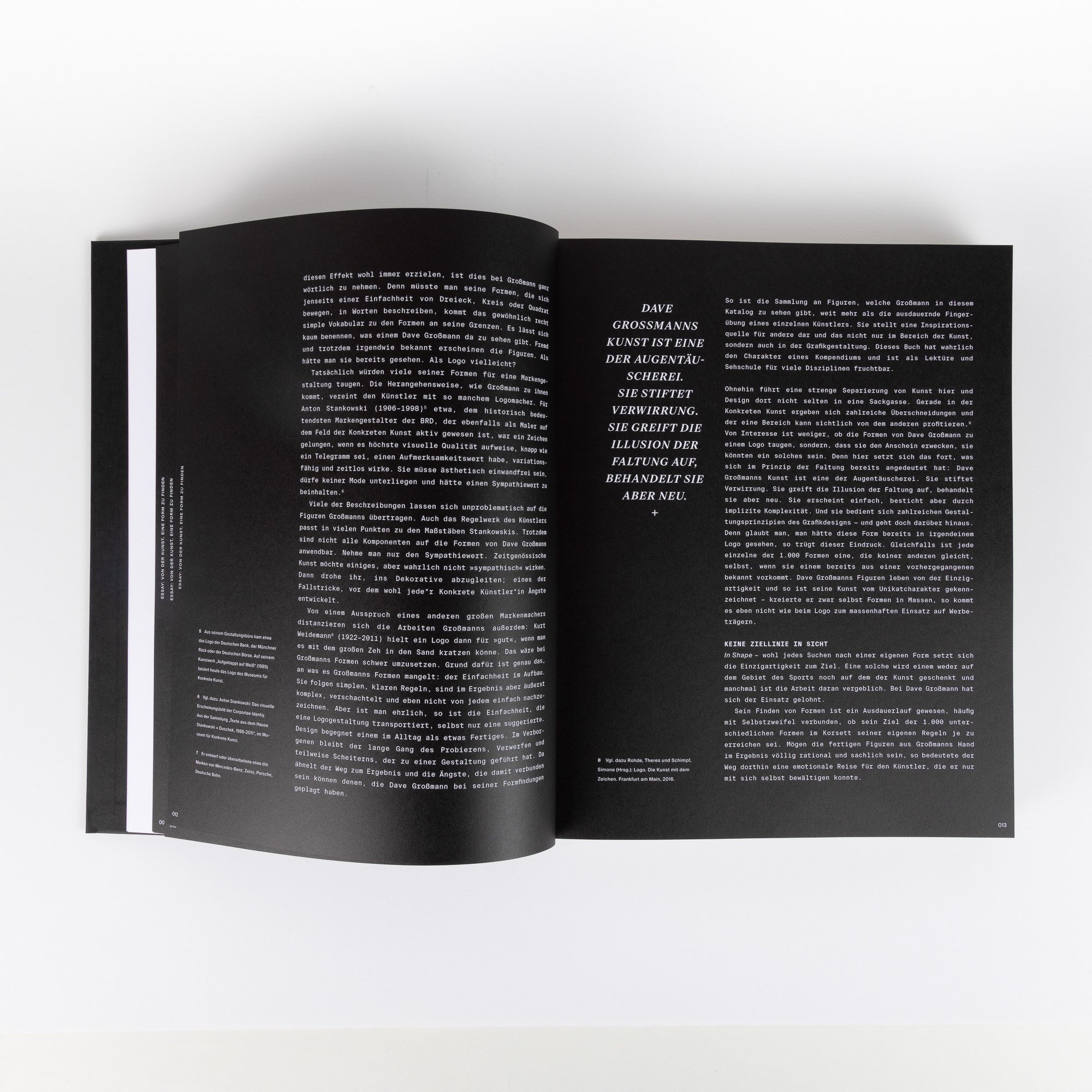 Open book showing two pages of text in German on black backgrounds with white font.