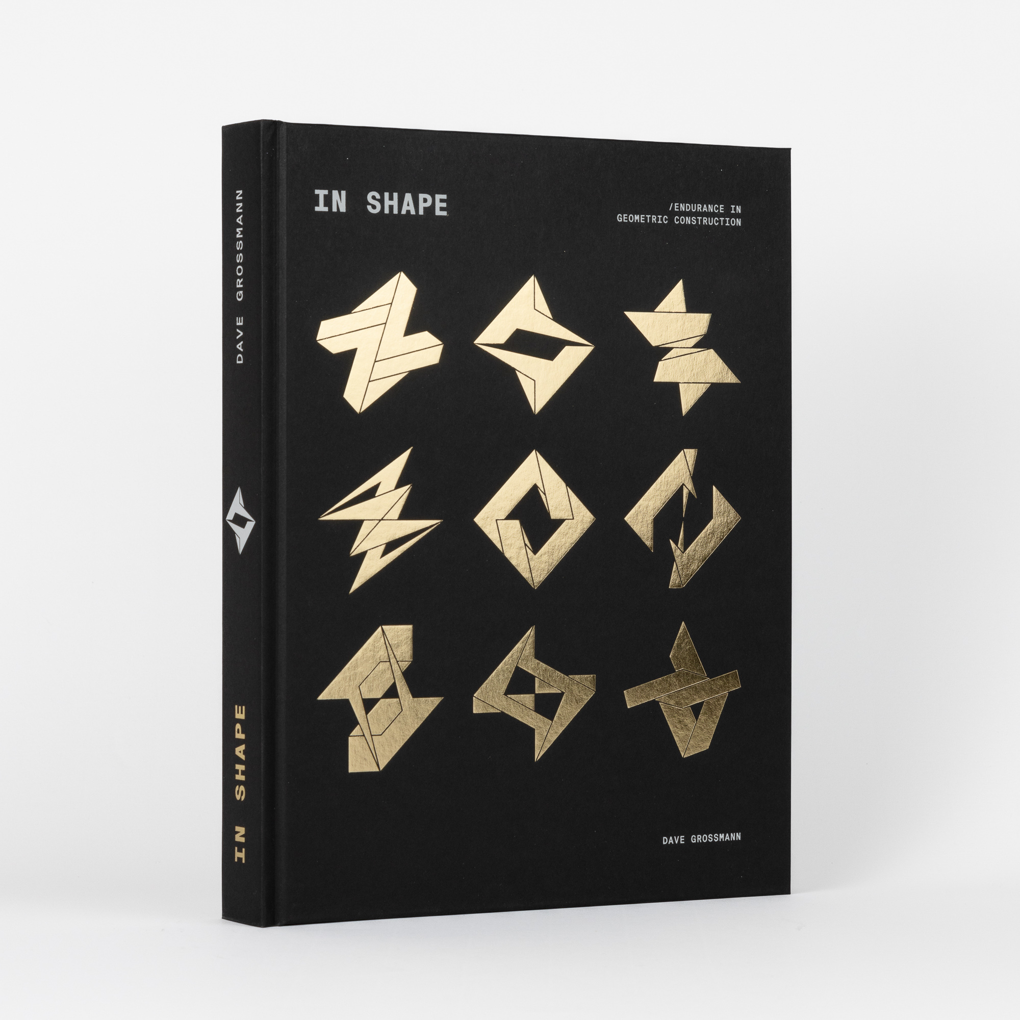 Black hardback book titled 'IN SHAPE' by Dave Grossmann featuring nine gold geometric shapes on the cover.