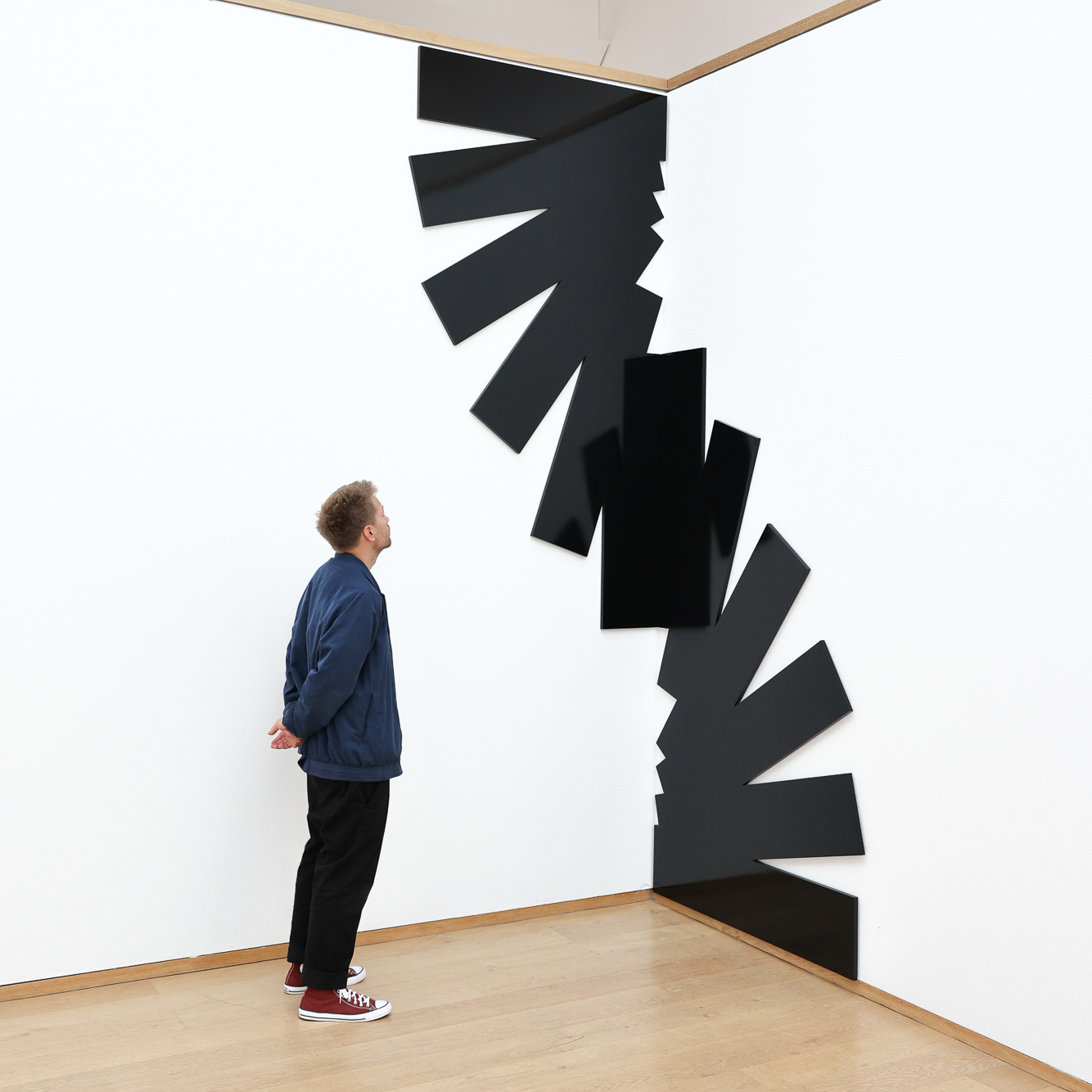 Nine abstract geometric shapes made of interconnected white lines arranged in a 3x3 grid on a black background.