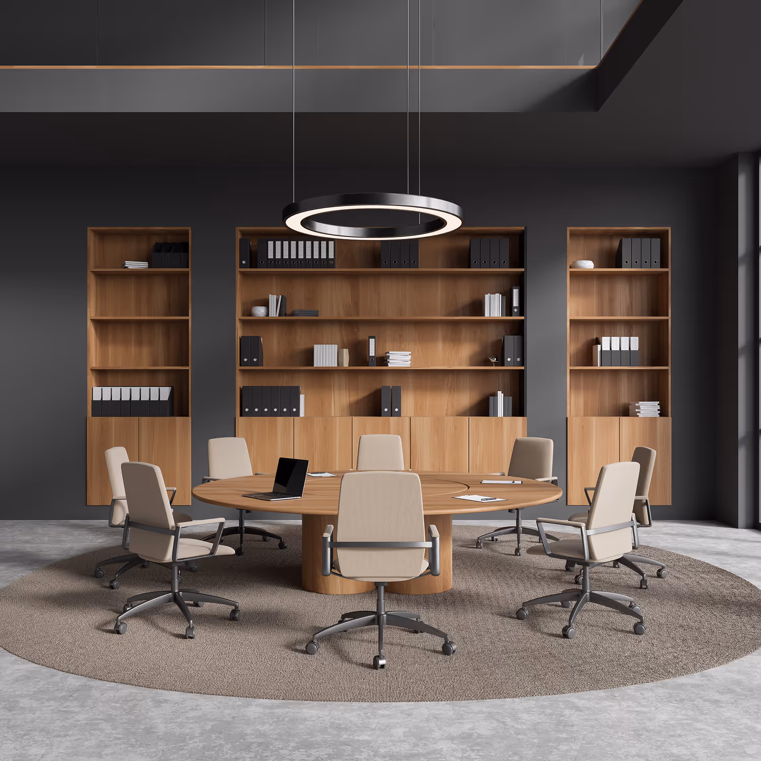 Modern conference room with a round wooden table surrounded by seven beige office chairs on a circular rug, and wooden shelves with neatly arranged folders and books against a dark gray wall.