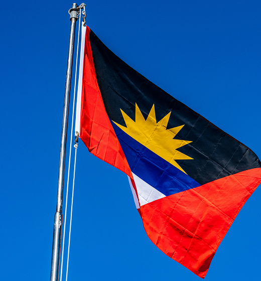 Better Flags | CiClO Flags | Antigua and Barbuda flag waving on a flagpole against a clear blue sky.