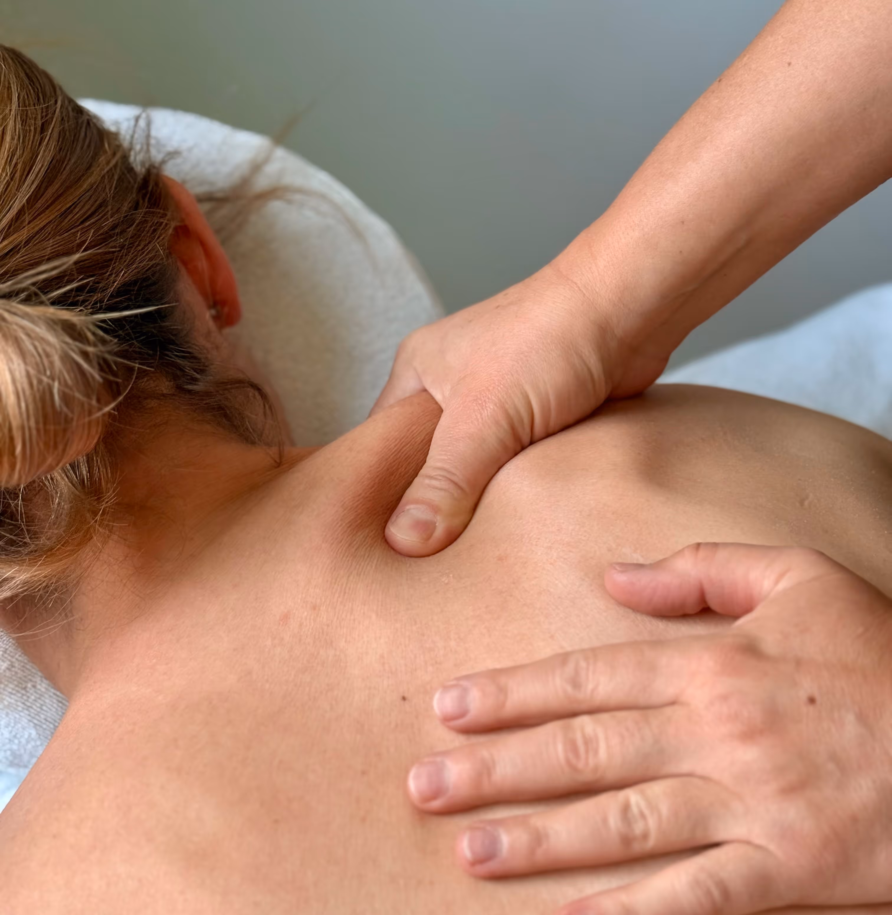 Csilla is massaging a woman's shoulder
