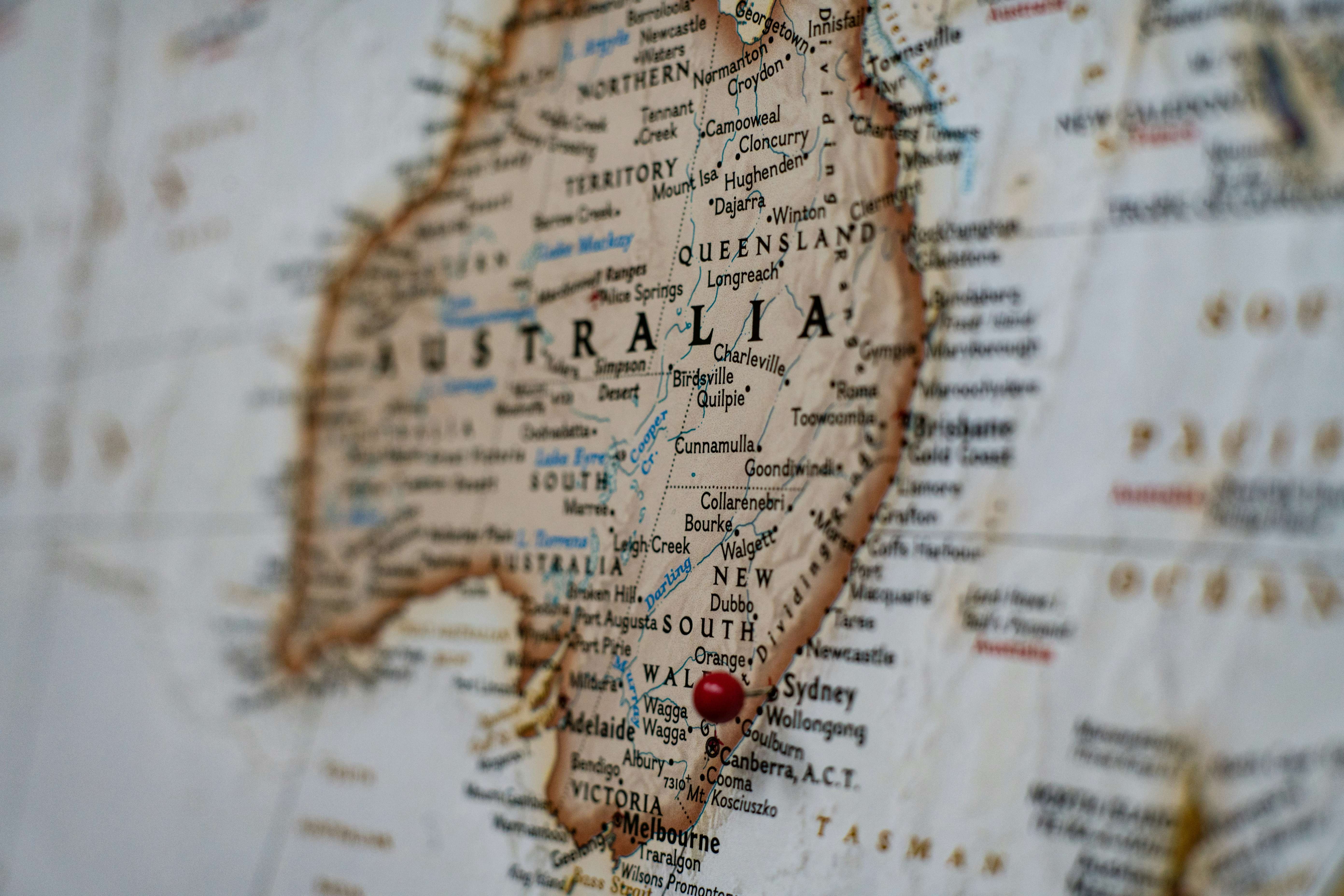 Close-up of a map highlighting southeastern Australia with a red pushpin near Canberra.