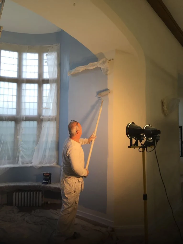 Levent, the founder, painting an alcove in Herstmonceux Castle (a Grade II listed building), as part of an interior decoration project