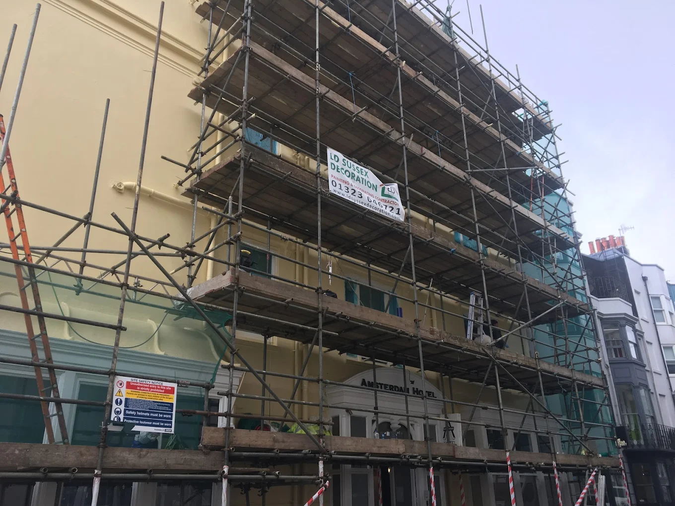 Scaffolding surrounding the exterior of Amsterdam Hotel, during a full exterior renovation project, led by LD Sussex Decoration