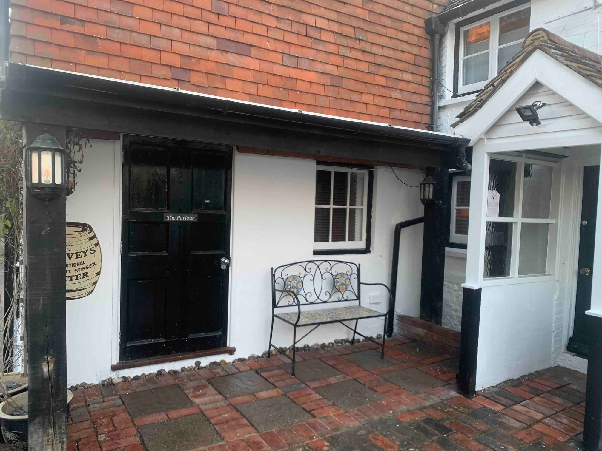 The recently painted front door and facade of a heritage cottage near Alciston, East Sussex