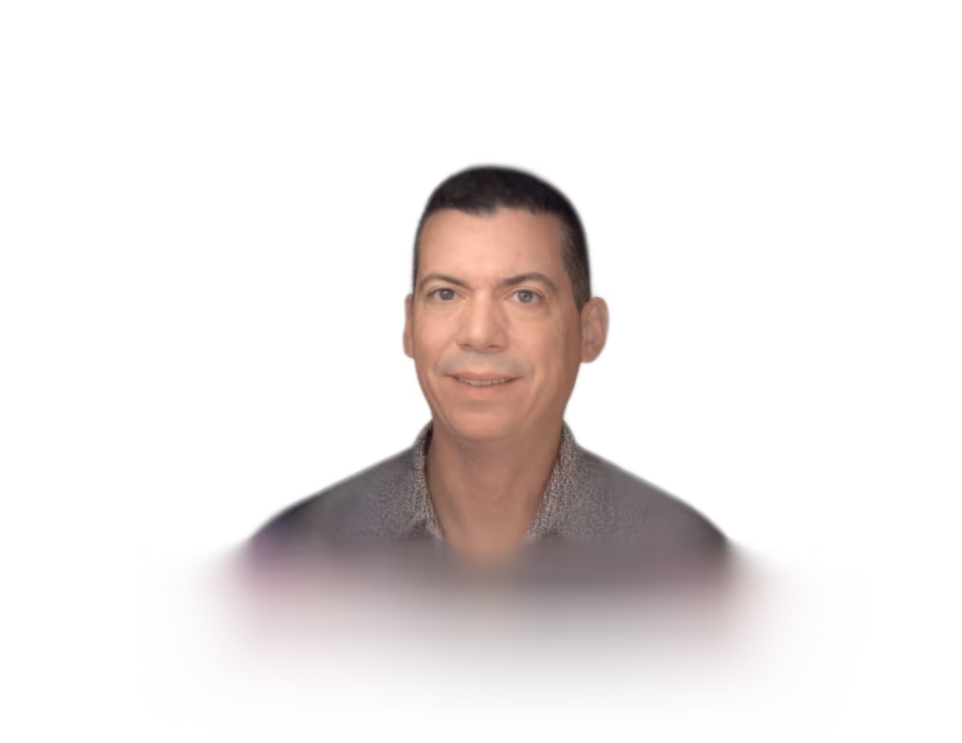 Florent persona. Smiling man with short black hair wearing a gray collared shirt against a black background.