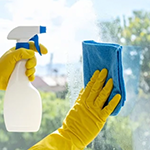 A hand cleaning a window