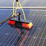 A photo of a solar panel being cleaned