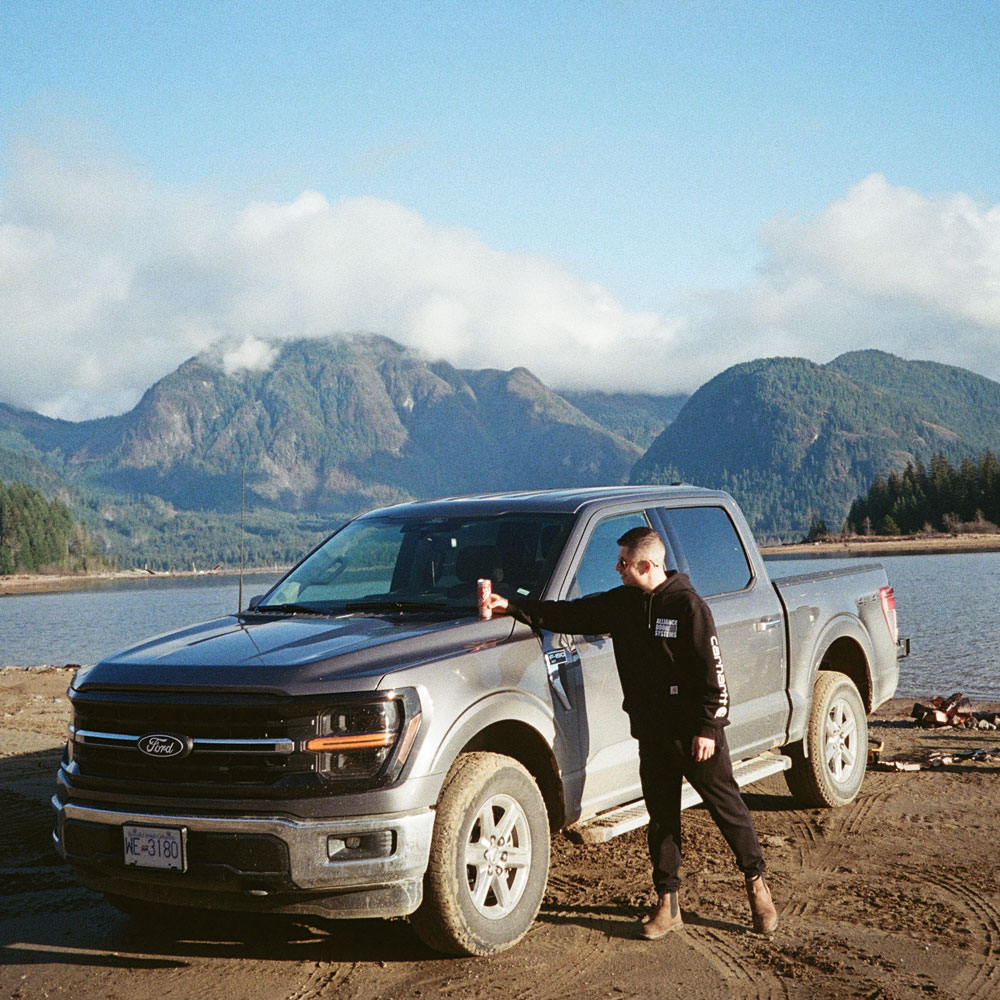 Alex Camino posing with his work truck.