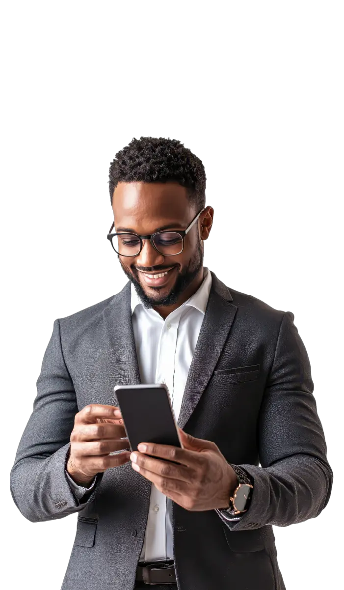 Smiling man in a dark suit with glasses looking at his smartphone.