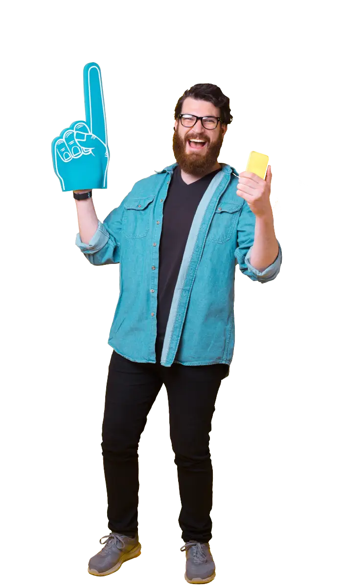 Cheerful bearded man wearing glasses and a denim shirt, holding a large blue foam finger and a yellow ticket.