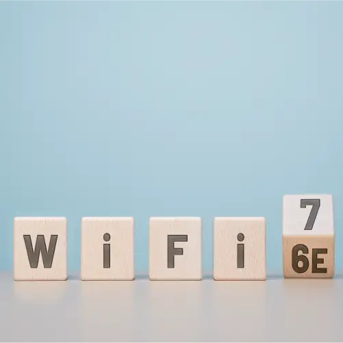Wooden blocks spelling 'WiFi' followed by a block transitioning from '6E' to '7'.