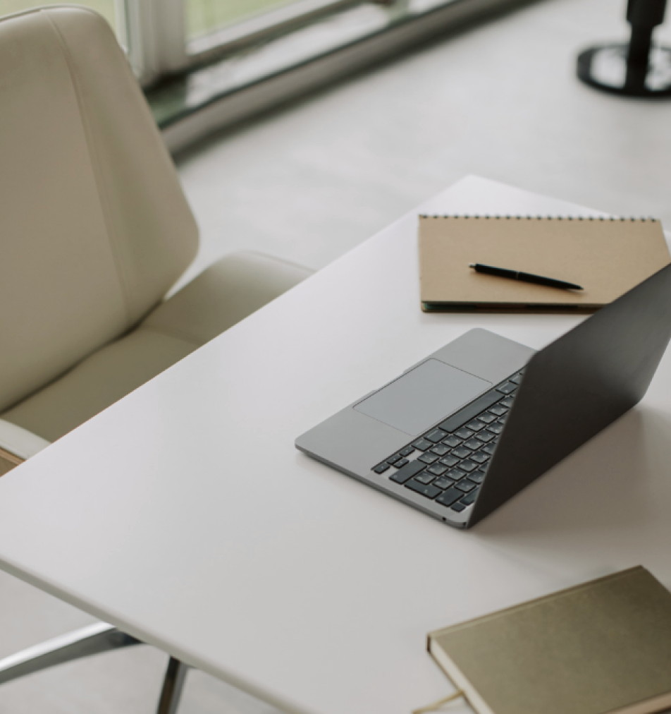 desk with open laptop computer sitting on top