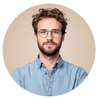 Man with curly hair, beard, and glasses in a circular frame.