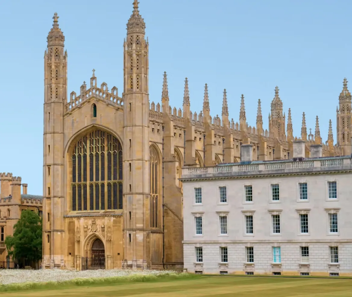 King's College Chapel with Gothic spires and large windows beside a white stone building in Cambridge.