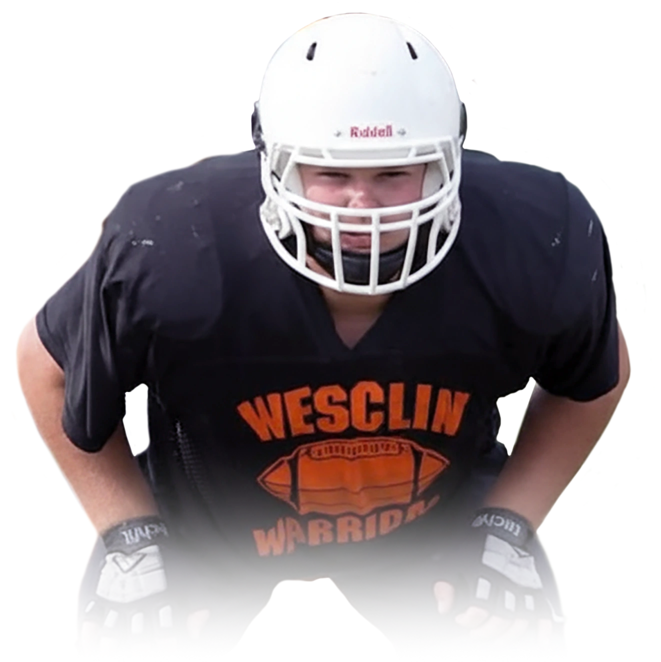 Football player wearing a white helmet and black Wesclin Warriors jersey in a ready stance.