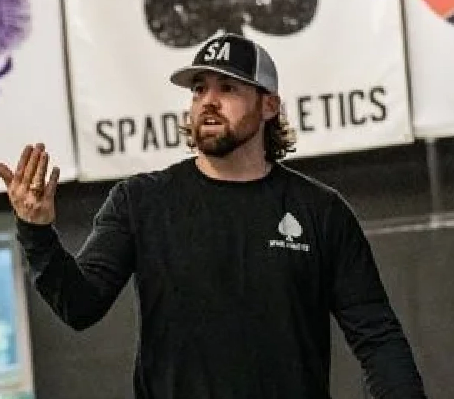 Spade Athletics coach addressing athletes inside the facility.
