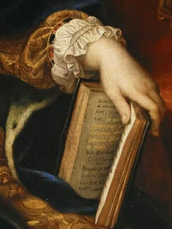 Close-up of a hand wearing a frilled cuff holding an open antique book with Latin text.