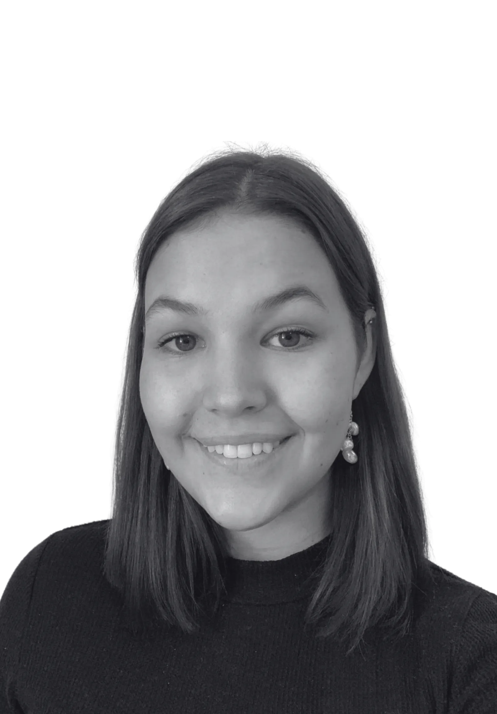 Smiling young woman with shoulder-length hair wearing a dark top and dangling earrings.