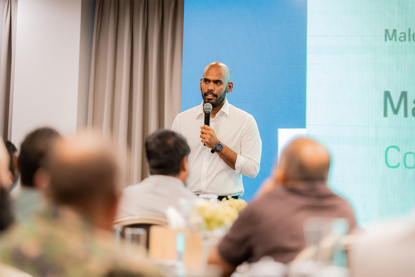 A speaker presenting to an audience at a Future Institute event