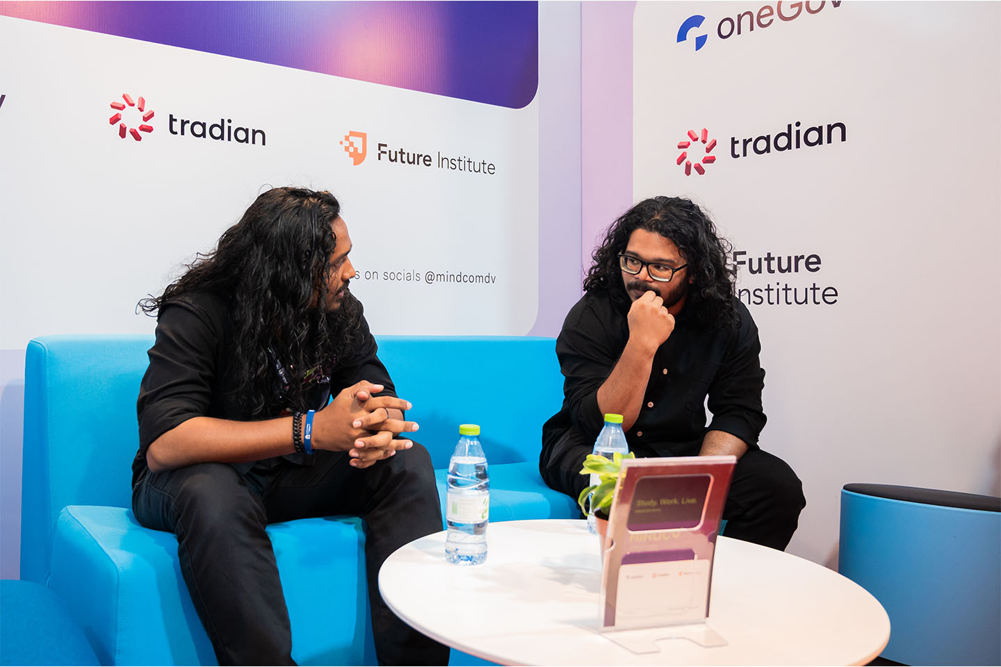 Two people in conversation at a Future Institute booth