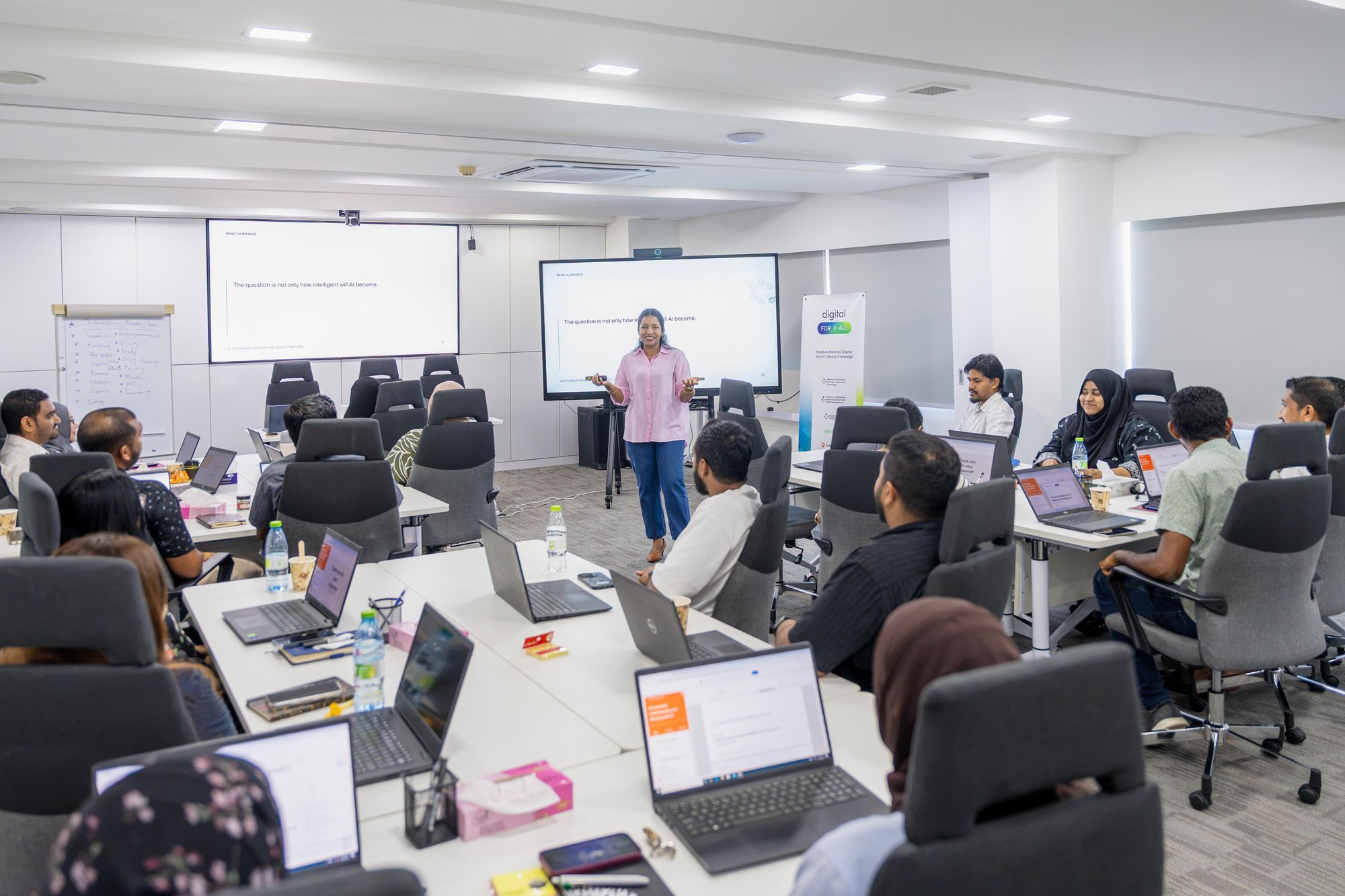 A facilitator leading a Future Institute training session for a full room