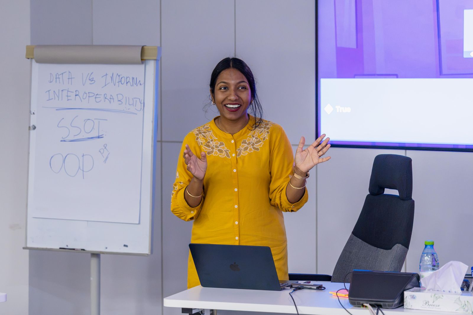 A facilitator explaining ideas at a flipchart during a training session
