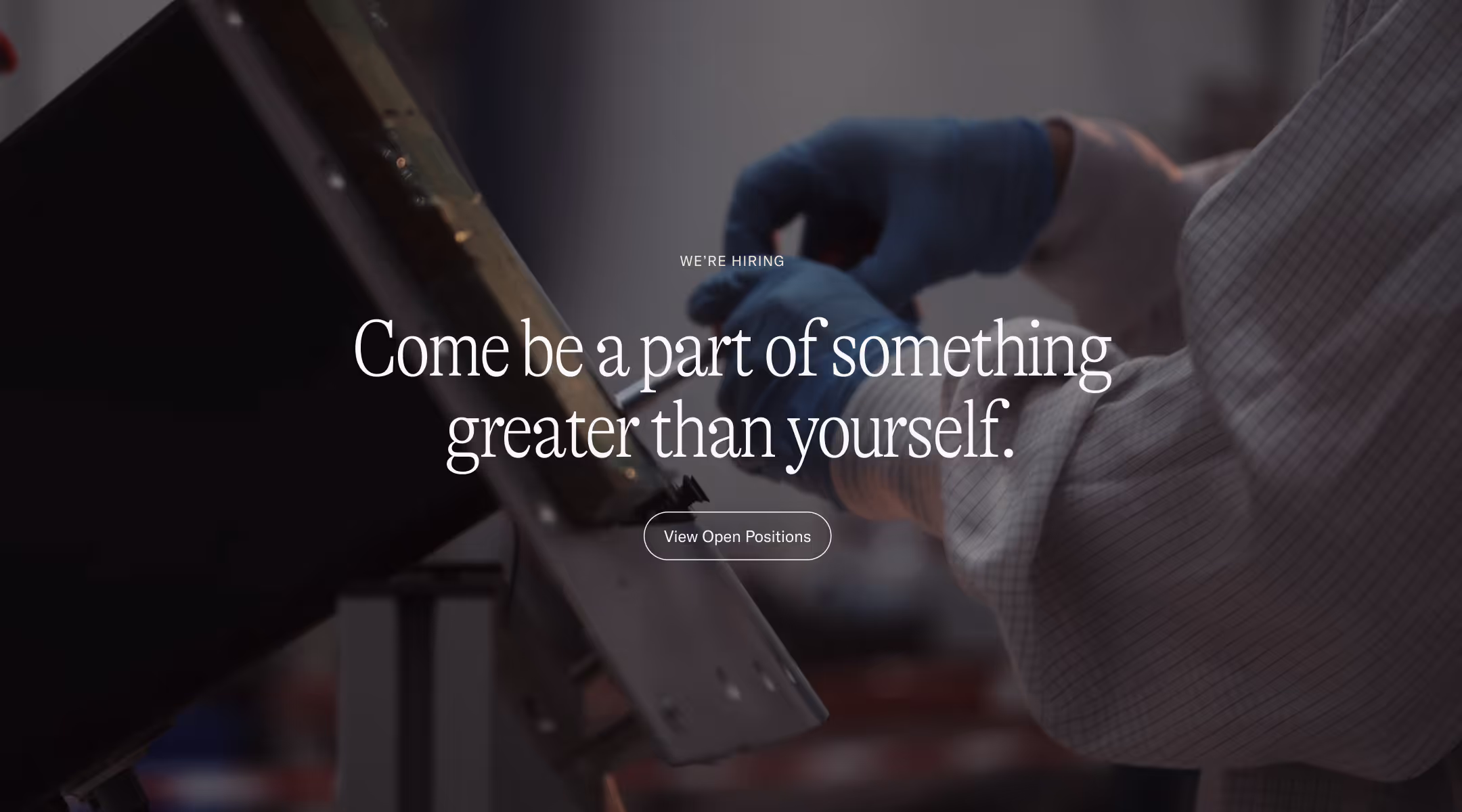 Person wearing blue gloves working with machinery, with text overlay inviting to join a team and view open positions.