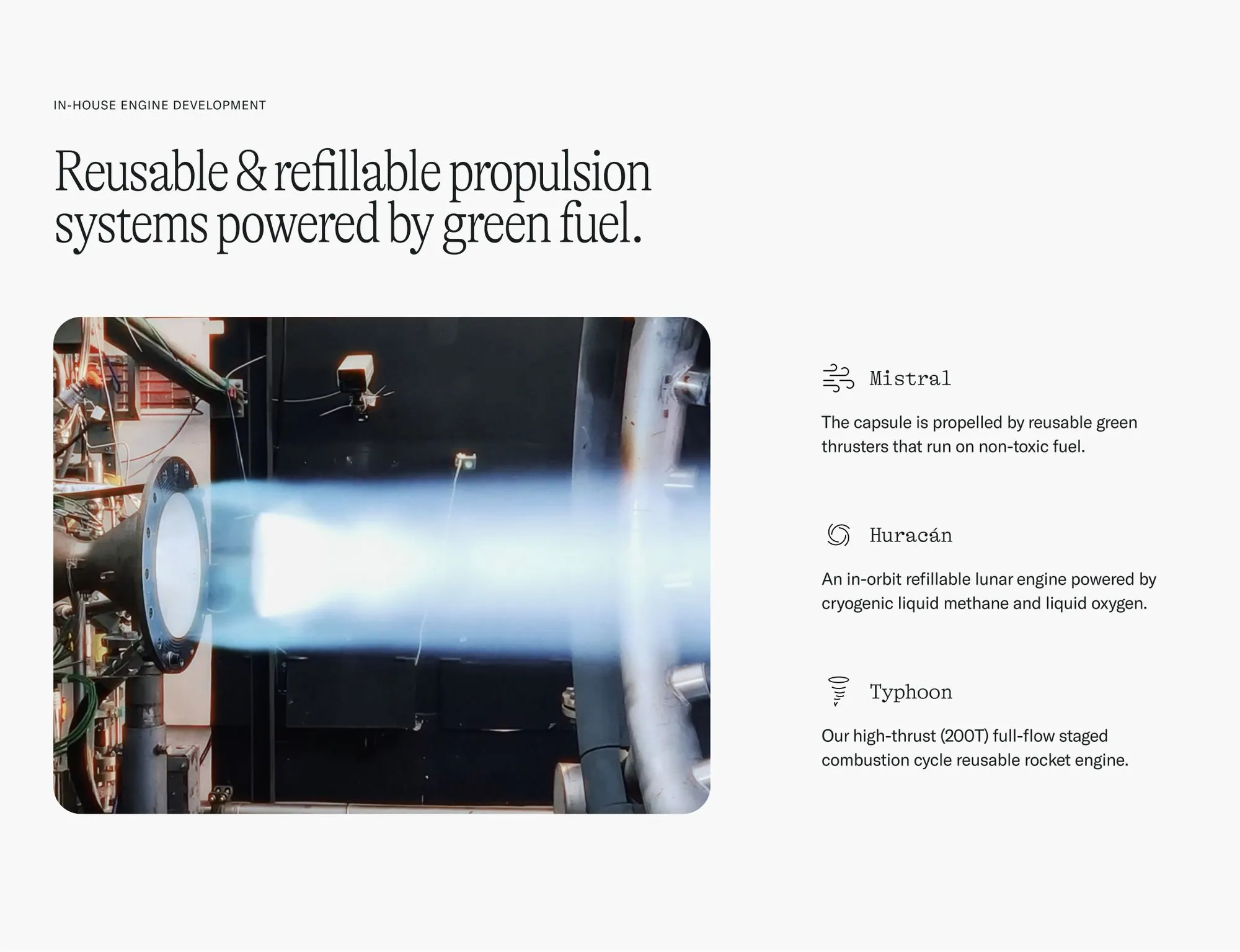 Blue flame exhaust from a rocket engine test firing in a lab.