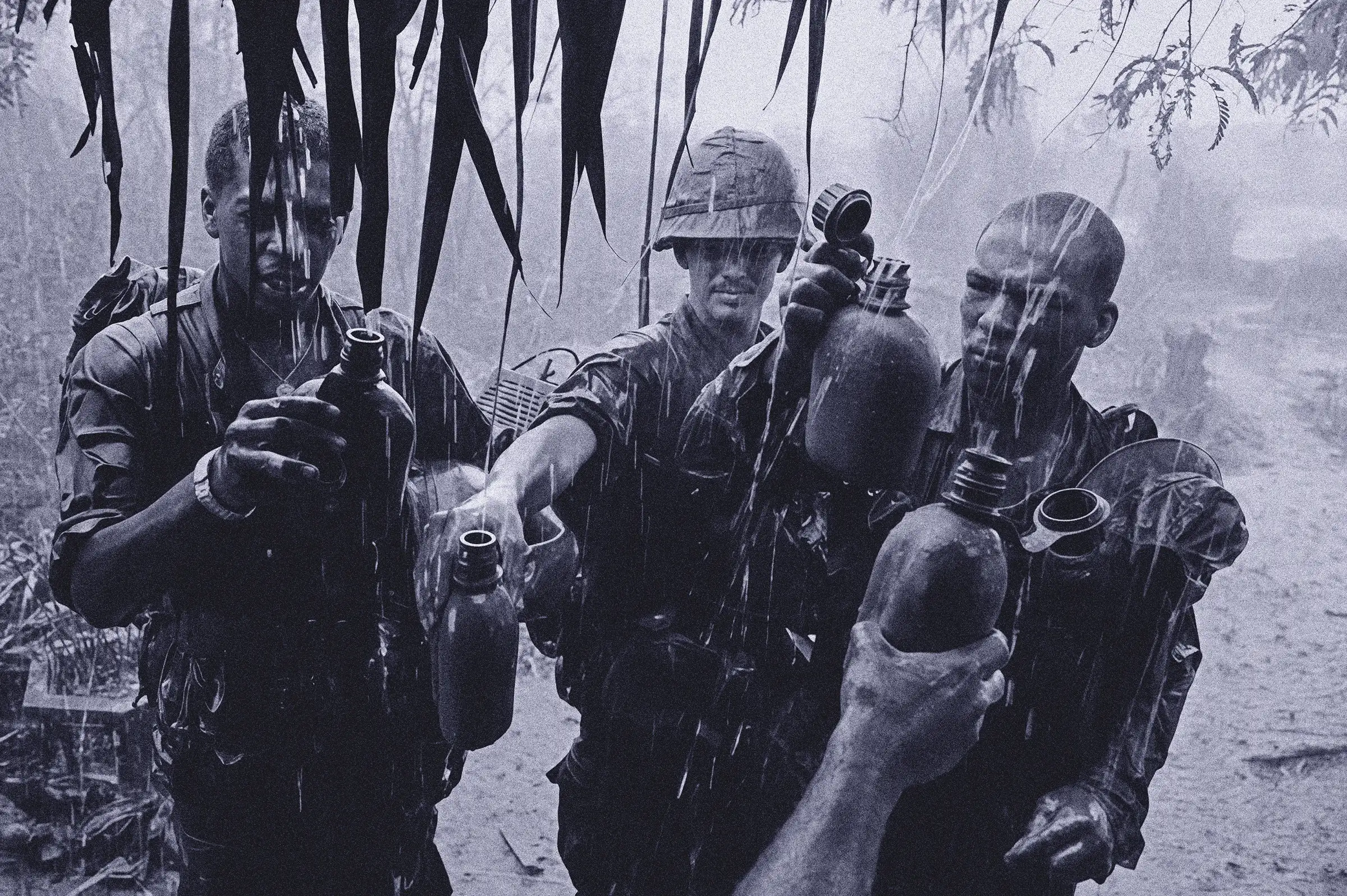 A man pouring water from a bottle into a cup.