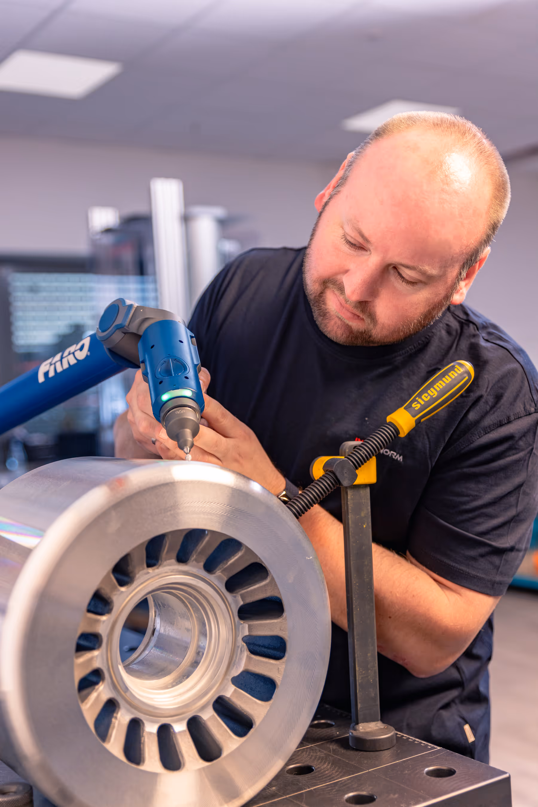 Quality management employee works on a metal core