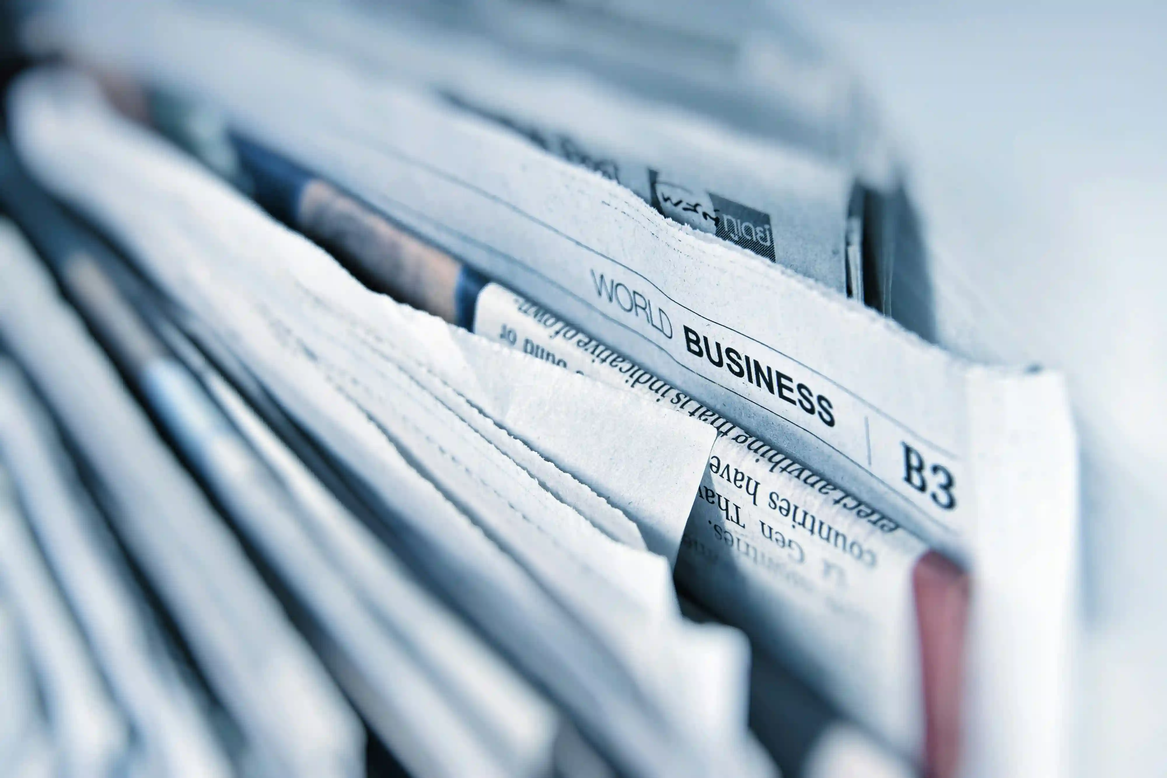 a stack of newspapers against a white background.