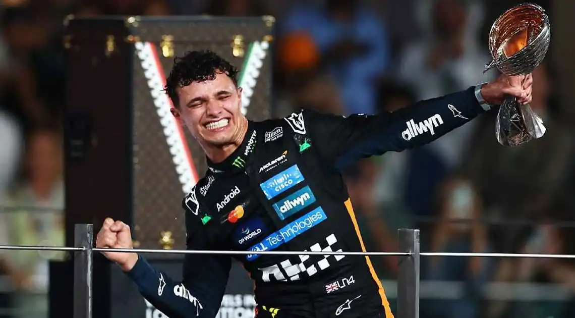 Lando Norris celebrating his world championship on the podium at the 2025 Abu Dhabi Grand Prix.