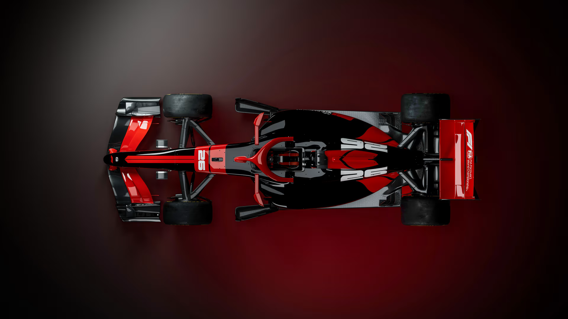A new 2026 F1 car in a red and black livery against a black floor from a top down view.