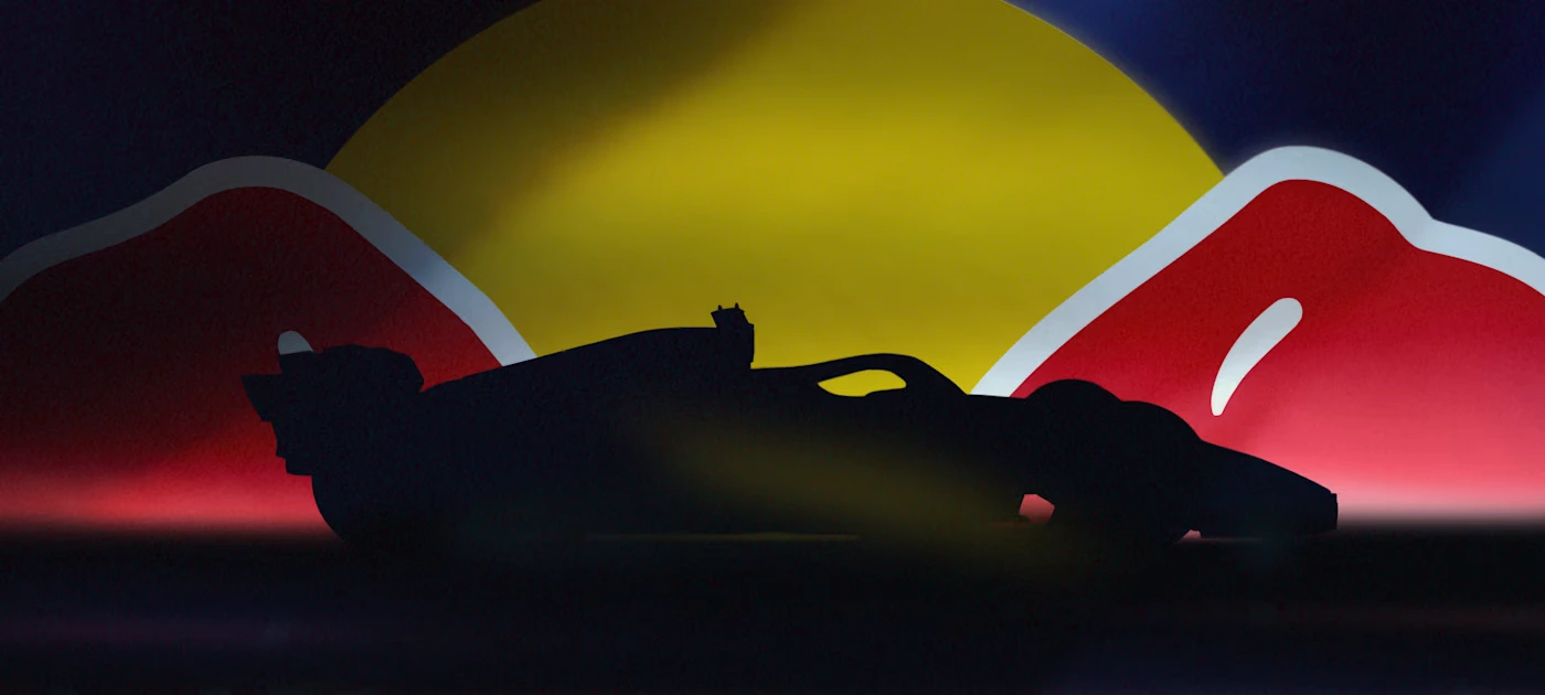 Red Bull's logo with a car's silhouette in front of it.