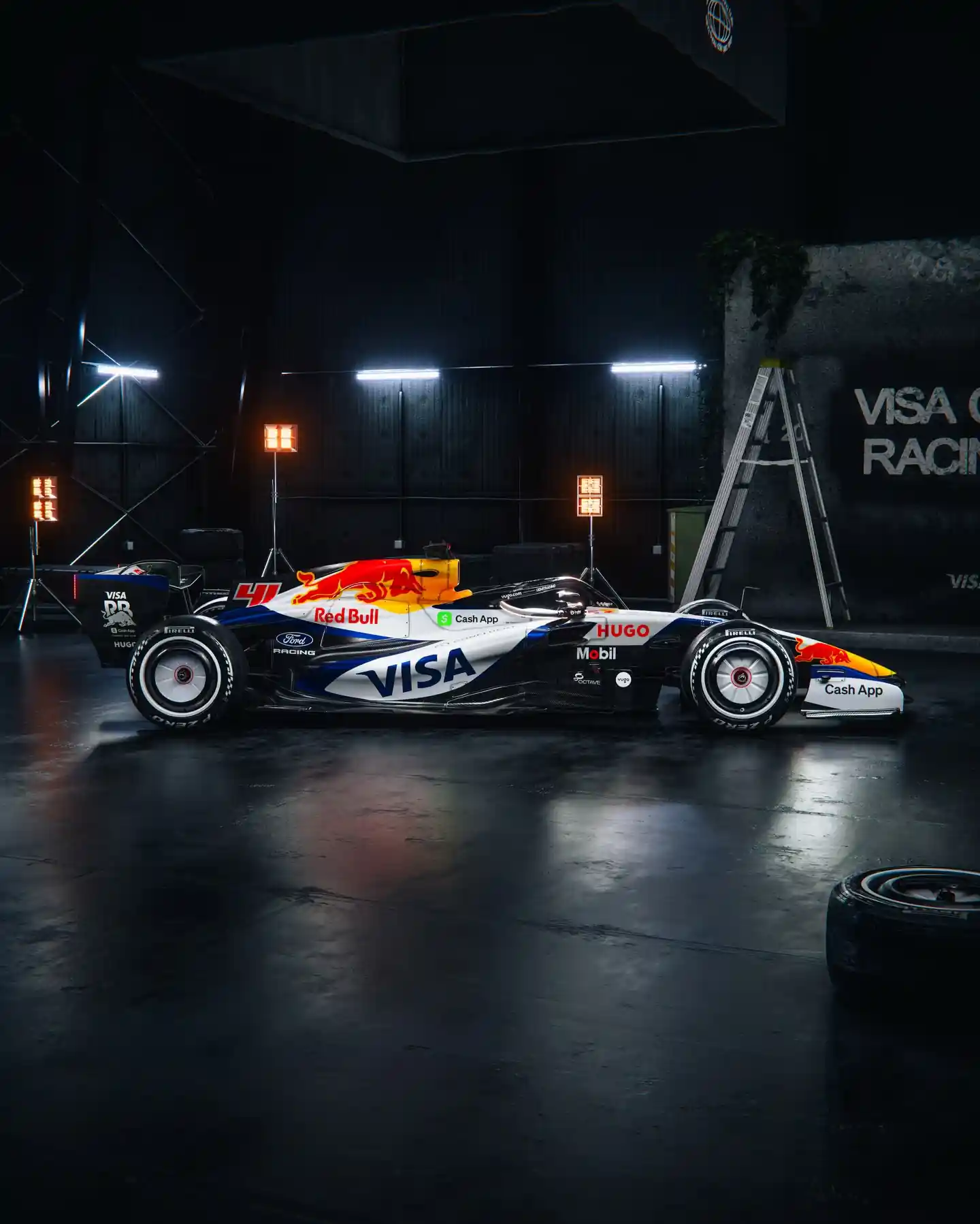 RB's white F1 car in a dark warehouse with lighting shining on it.