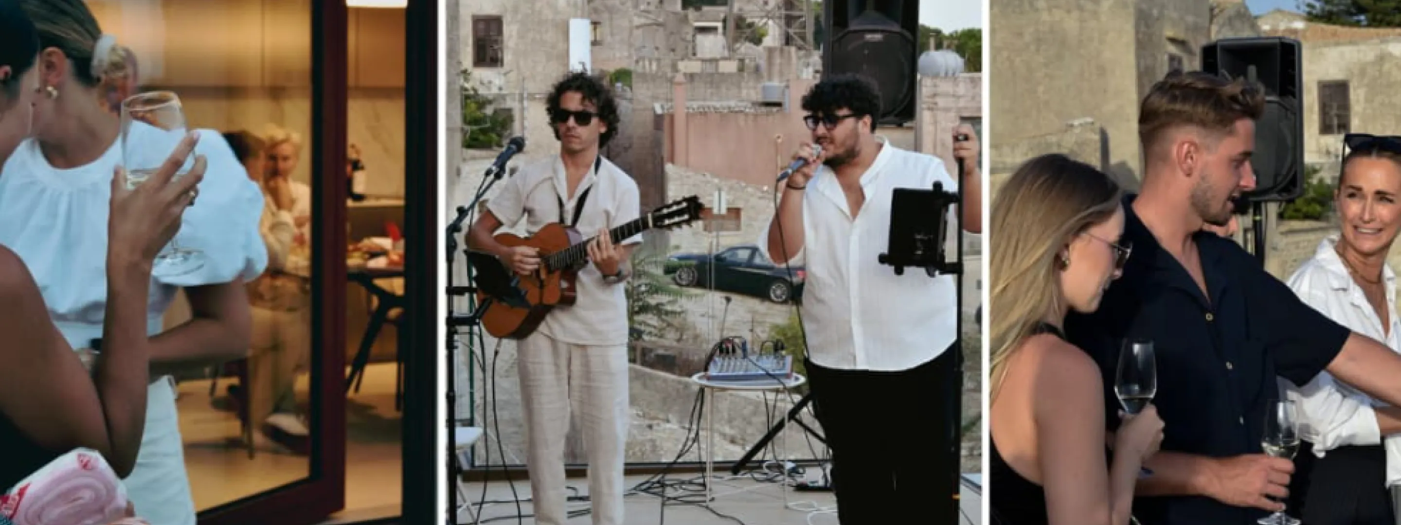 Two men performing live music outdoors with one playing guitar and the other singing into a microphone.