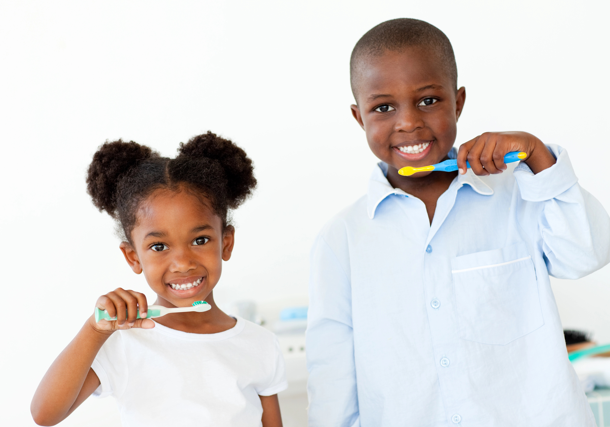 two kids brushing teeth as part of pediatric dental care (1)