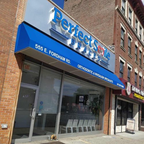Perfect Smile Braces storefront with a blue awning on a city street