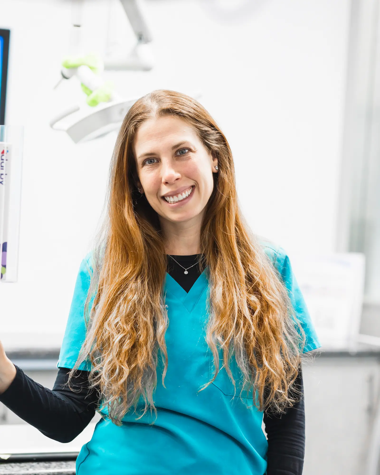 a woman in a blue shirt smiling