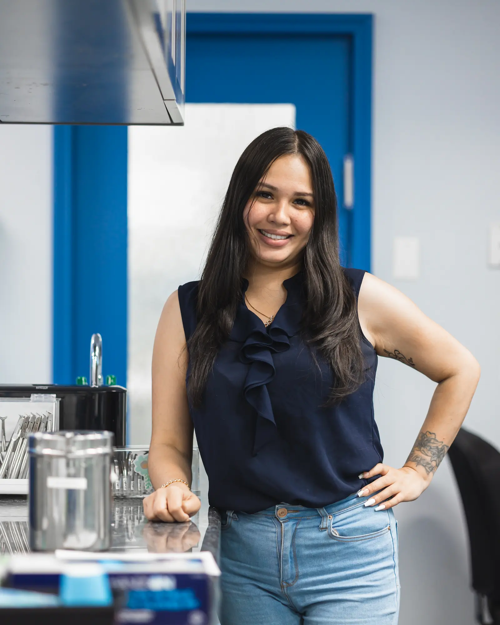a woman standing next to a counter in a dental office