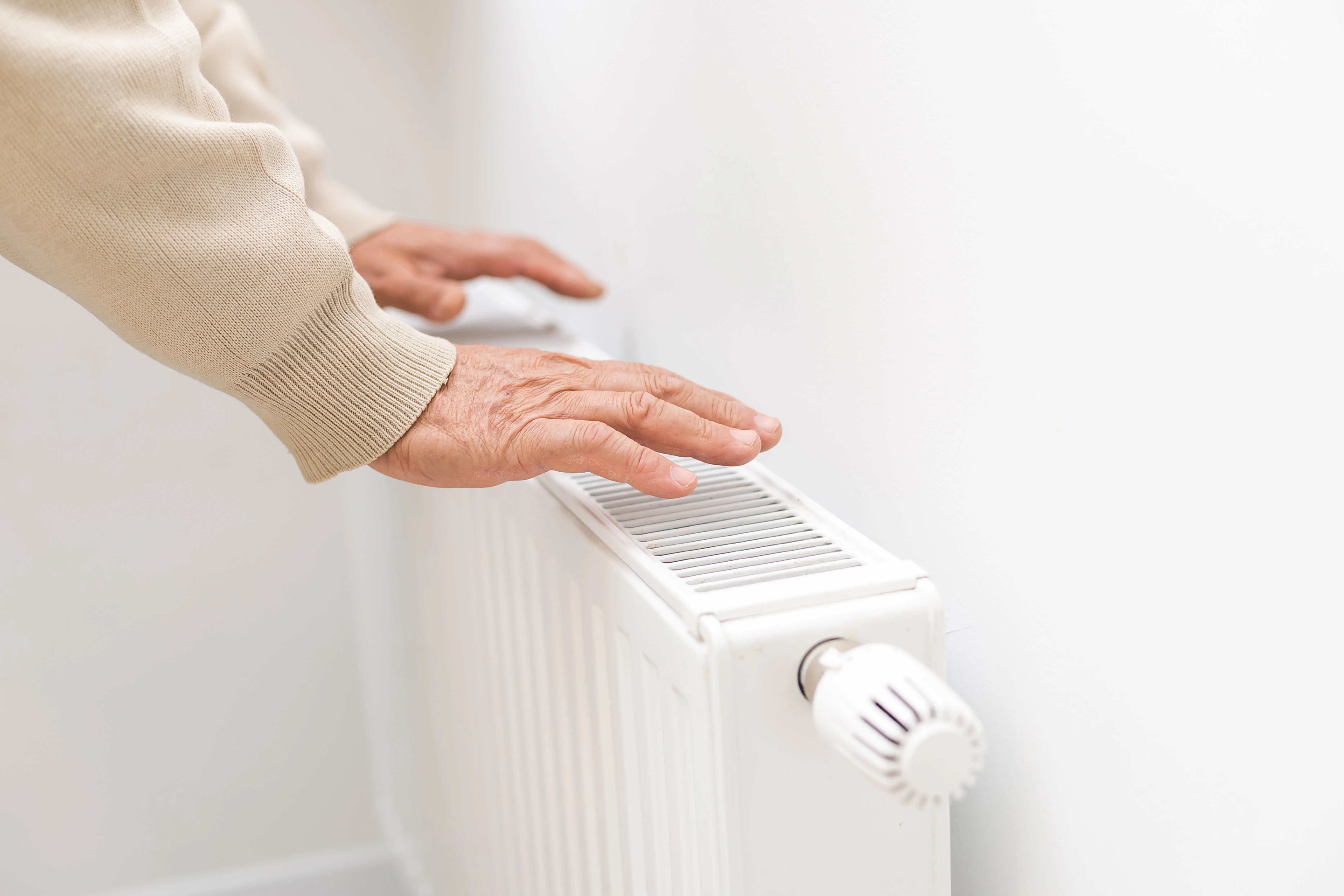 Hands above a radiator