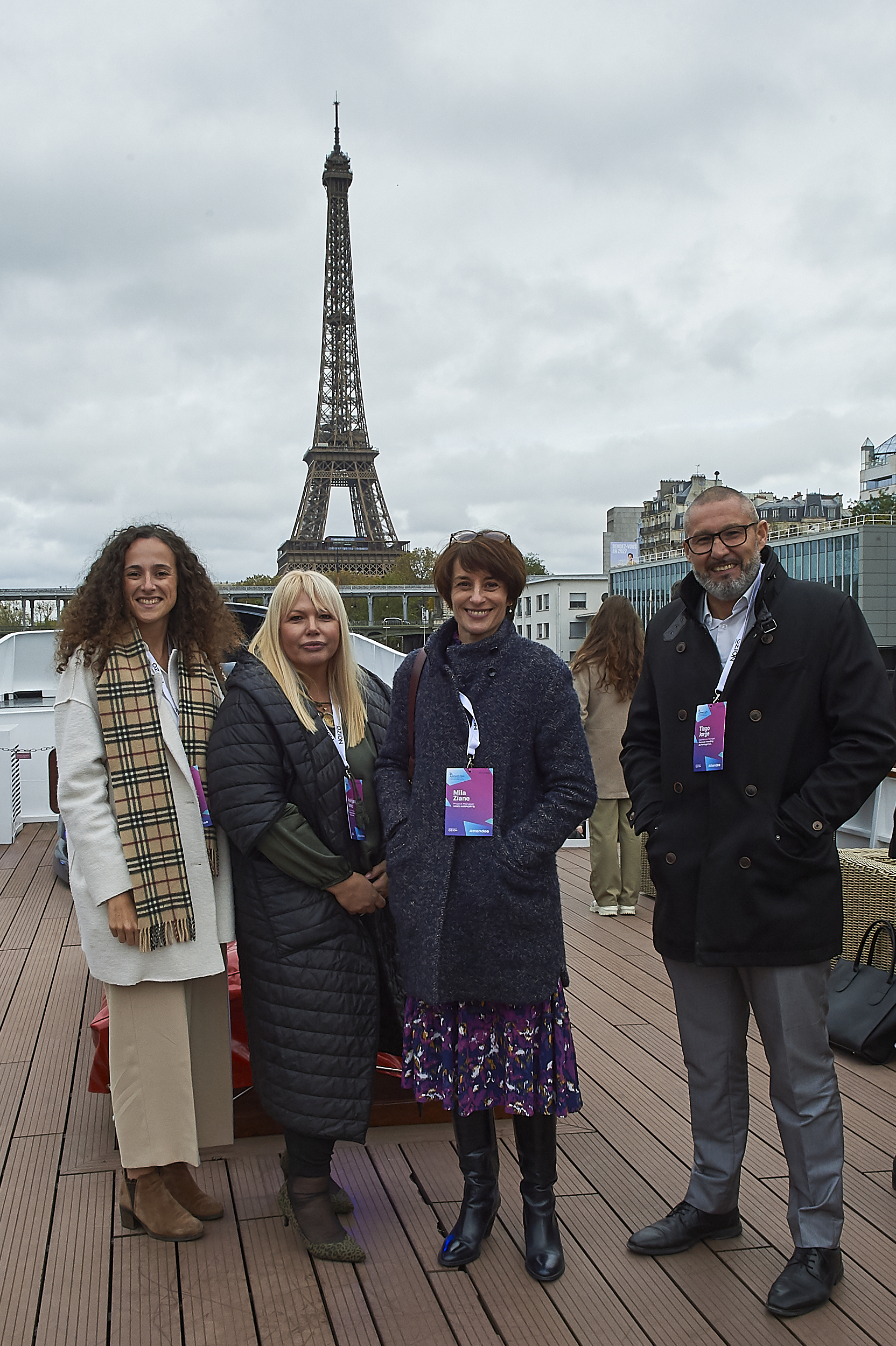 Delegates on the deck of the conference venue with the Eiffel Tower behind them