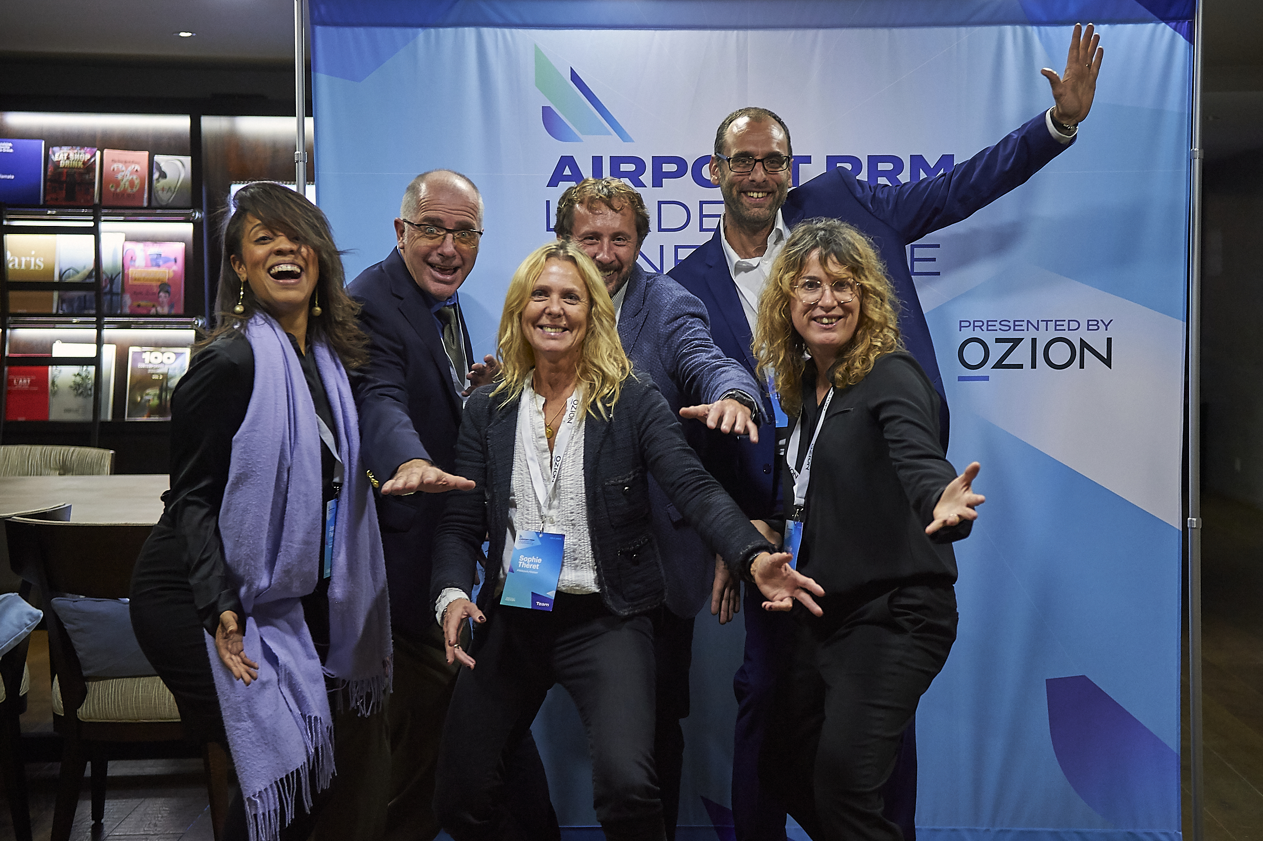 Delegates having fun at the Airport PRM Leadership Conference photo wall in Paris