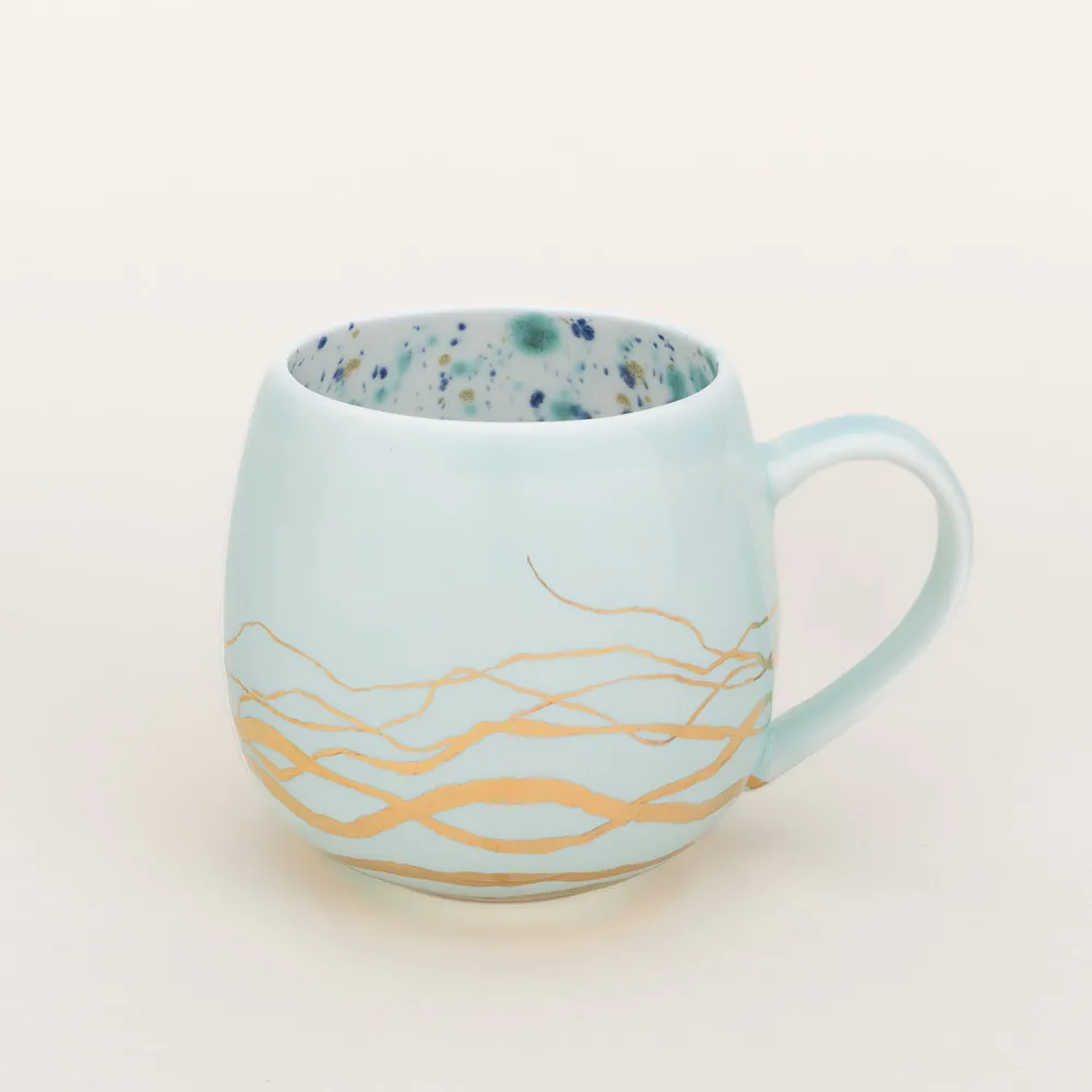 Hand-glazed Mediterranean blue coffee mug made in Italy by Coralla Maiuri with a playful interpretation of Roman antiquity