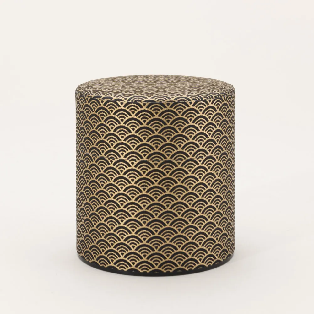 Japanese tea canister wrapped in traditional washi paper bearing the Seigaiha design
