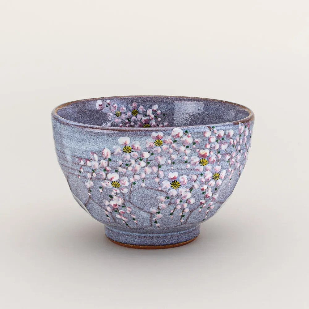 Dimpled chawan with hand-painted cherry blossoms over a brushed purple glaze made by Murakami lku in Kyoto, Japan