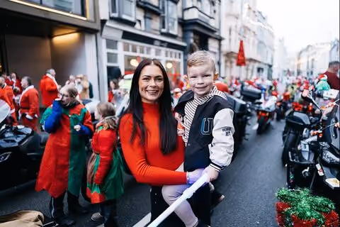 A family cheering at the Santa's on a Bike event